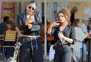 Two young women looking at their smartphones